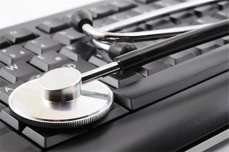 stethoscope on keyboard showing computer problem concept Stock Photo - Budget Royalty-Free & Subscription, Code: 400-04241424