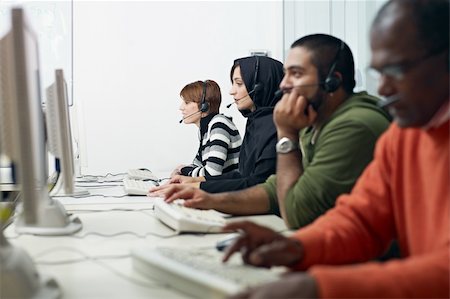 Multiethnic computer class with indian, middle eastern, hispanic and caucasian people training with pc. Horizontal shape, side view, waist up Stock Photo - Budget Royalty-Free & Subscription, Code: 400-04241478