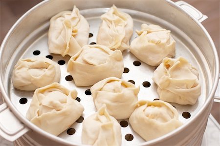 Uncooked oriental dumplings on metal steam cooker Stock Photo - Budget Royalty-Free & Subscription, Code: 400-04241523