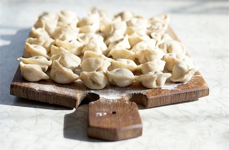 simsearch:400-04025064,k - Uncooked meat dumplings on kitchen preparation table Stock Photo - Budget Royalty-Free & Subscription, Code: 400-04241543
