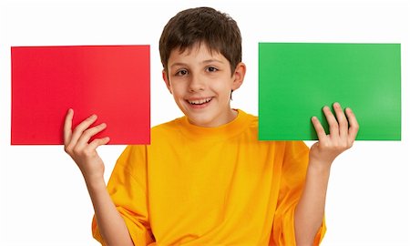 A boy is holding two sheets of different color papper; isolated on the white background Stock Photo - Budget Royalty-Free & Subscription, Code: 400-04242078