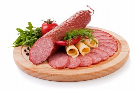 salami plate - Sliced sausage with vegetables on a wooden plate isolated Stock Photo - Budget Royalty-Free & Subscription, Code: 400-04242614