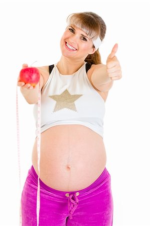 simsearch:400-04798379,k - Smiling pregnant woman with measure tape and apple showing thumbs up gesture Foto de stock - Super Valor sin royalties y Suscripción, Código: 400-04243268