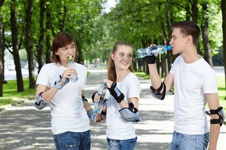 Young people in equipment in park drink water Stock Photo - Budget Royalty-Free & Subscription, Code: 400-04243327