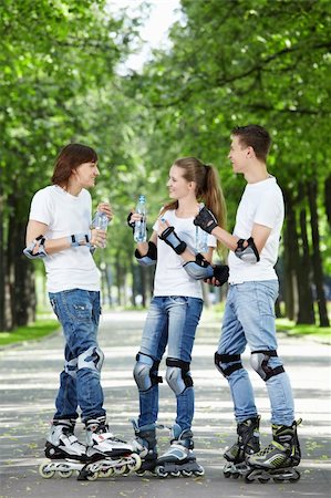 Three young skaters are drinking water in the park Stock Photo - Budget Royalty-Free & Subscription, Code: 400-04243328