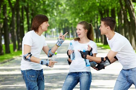 Three young people in the outfit of drinking water Stock Photo - Budget Royalty-Free & Subscription, Code: 400-04243330