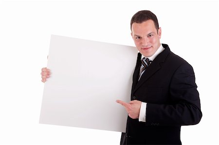employee hold a sign - handsome businessman holding a whiteboard and pointing, looking at the camera and smiling, isolated on white, studio shot Stock Photo - Budget Royalty-Free & Subscription, Code: 400-04243387