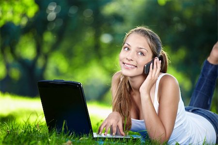 Attractive girl with laptop talking on the phone Stock Photo - Budget Royalty-Free & Subscription, Code: 400-04243410