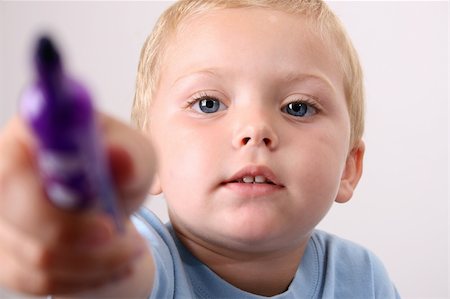 simsearch:400-05284316,k - Toddler pointing his purple pen towards the camera Stockbilder - Microstock & Abonnement, Bildnummer: 400-04255633