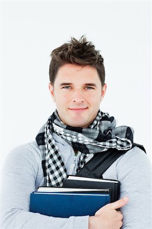 simsearch:400-04854970,k - Young man wearing a scarf squeezing books against himself Stock Photo - Budget Royalty-Free & Subscription, Code: 400-04256093