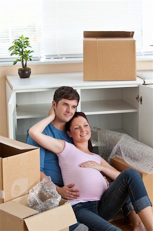 adorable couple sitting on the floor in their new house during removal looking the front Stock Photo - Budget Royalty-Free & Subscription, Code: 400-04256445