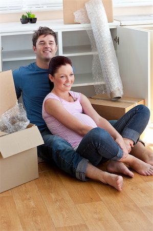 joyful young future parents sitting on the floor surrounded by cardboards in their new house Stock Photo - Budget Royalty-Free & Subscription, Code: 400-04256455