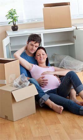 future parents relaxing on the floor during a break after unpacking boxes in their new house Stock Photo - Budget Royalty-Free & Subscription, Code: 400-04256457