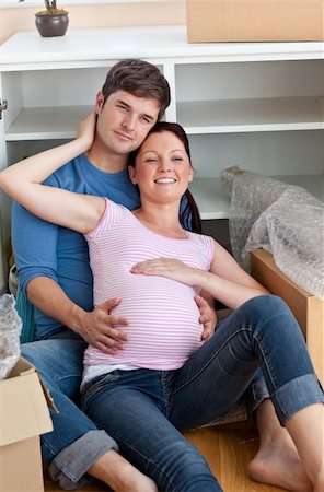 portrait of future parents in their new home sitting in their new kitchen among cardboard boxes Stock Photo - Budget Royalty-Free & Subscription, Code: 400-04256459