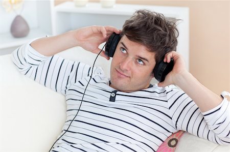 simsearch:400-04207132,k - thoughful man listening music looking the top sitting in the sofa at home Foto de stock - Super Valor sin royalties y Suscripción, Código: 400-04256469