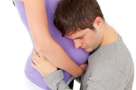 simsearch:400-07322828,k - close-up of young man listening carefully the belly of his wife against a white background Fotografie stock - Microstock e Abbonamento, Codice: 400-04256474