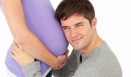 simsearch:400-07322828,k - affectionate young man listening to the belly of his pregnant wife smiling against a white background Fotografie stock - Microstock e Abbonamento, Codice: 400-04256473