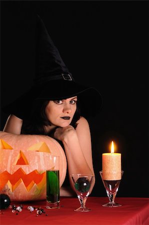 simsearch:400-06135836,k - Young witch with a pumpkin on a black  background Stock Photo - Budget Royalty-Free & Subscription, Code: 400-04256515