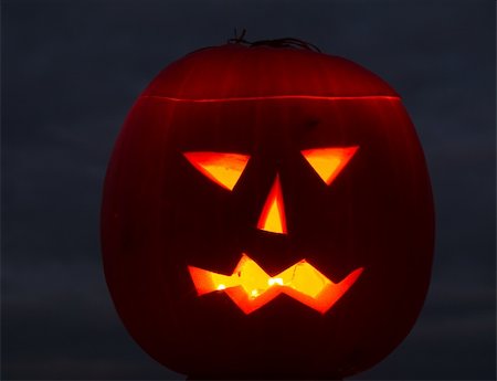 simsearch:400-07793717,k - Halloween pumpkin on grey cloudy background lit by candles Photographie de stock - Aubaine LD & Abonnement, Code: 400-04256547