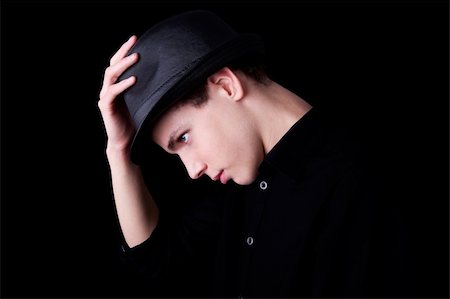 simsearch:400-07316542,k - Young man wearing a hat over black background, studio shot Stock Photo - Budget Royalty-Free & Subscription, Code: 400-04256604