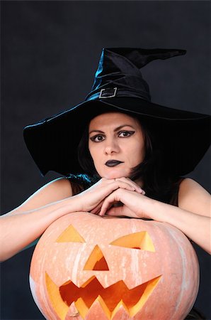 simsearch:400-06135836,k - Young witch with a pumpkin on a black  background Stock Photo - Budget Royalty-Free & Subscription, Code: 400-04256665