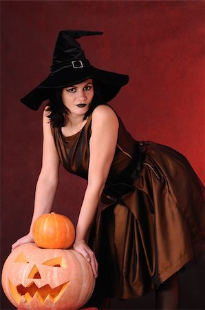 simsearch:400-06135836,k - Young witch with a pumpkin on a black  background Stock Photo - Budget Royalty-Free & Subscription, Code: 400-04256666