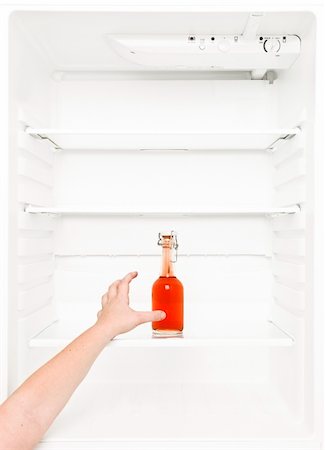 Human hand trying to reach a bottle in the fridge Stock Photo - Budget Royalty-Free & Subscription, Code: 400-04256788
