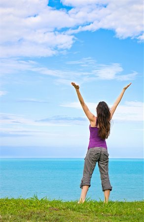 simsearch:400-04982004,k - A beautiful young woman standing with her arms up in the air looking at the ocean Stock Photo - Budget Royalty-Free & Subscription, Code: 400-04256902
