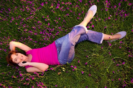 Top view of beautiful young woman lying on the nature and talking at cellphone Stock Photo - Budget Royalty-Free & Subscription, Code: 400-04256987