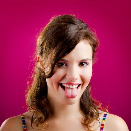 Portrait of a beautiful young woman with her tongue out Foto de stock - Super Valor sin royalties y Suscripción, Código: 400-04257034