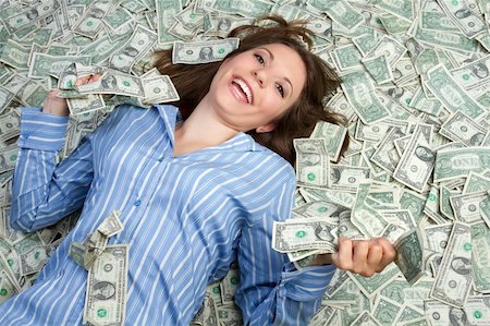 Beautiful woman laying in money Stock Photo - Budget Royalty-Free & Subscription, Code: 400-04257821