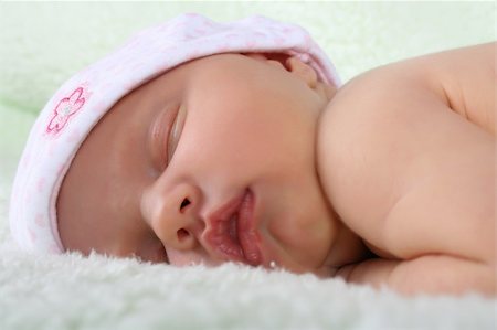 Beautiful newborn baby girl sleeping on a fluffy blanket Stock Photo - Budget Royalty-Free & Subscription, Code: 400-04258231