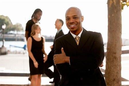simsearch:400-04745083,k - An african american business man with colleagues in the background Foto de stock - Royalty-Free Super Valor e Assinatura, Número: 400-04259603