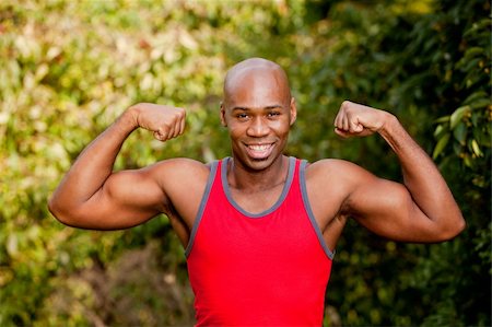 An African American man flexing his Bicep Stock Photo - Budget Royalty-Free & Subscription, Code: 400-04259625