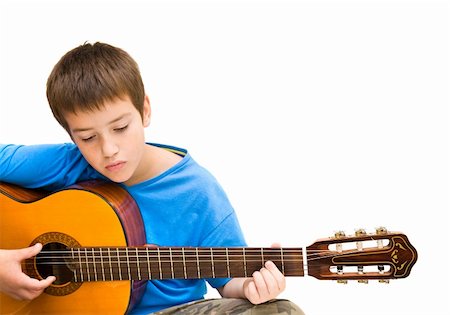 preteens fingering - caucasian boy learning to play acoustic guitar, isolated on white background; horizontal crop Stock Photo - Budget Royalty-Free & Subscription, Code: 400-04265077