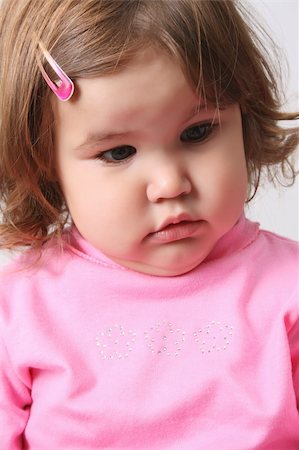 fat baby girl - Toddler girl with chubby cheeks wearing a pink top Foto de stock - Super Valor sin royalties y Suscripción, Código: 400-04265220