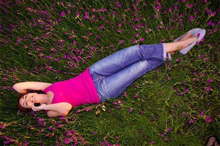 Top view of beautiful young woman lying on the nature and talking at cellphone Stock Photo - Budget Royalty-Free & Subscription, Code: 400-04265804