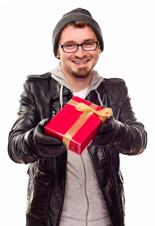 Warmly Dressed Handsome Young Man Handing Wrapped Gift Out Isolated on a White Background. Stock Photo - Budget Royalty-Free & Subscription, Code: 400-04265961