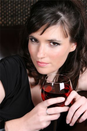 simsearch:400-04266572,k - Female model with intense eyes holding a glass of red wine Stock Photo - Budget Royalty-Free & Subscription, Code: 400-04266344