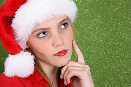 simsearch:400-04763033,k - Christmas in deep thought wearing a christmas hat Photographie de stock - Aubaine LD & Abonnement, Code: 400-04266341