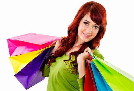 Stock image of cheerful woman holding shopping bags over white background Stock Photo - Budget Royalty-Free & Subscription, Code: 400-04266794