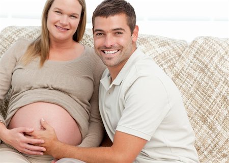 simsearch:400-04266840,k - Happy future mom and dad relaxing in their living room Photographie de stock - Aubaine LD & Abonnement, Code: 400-04266835