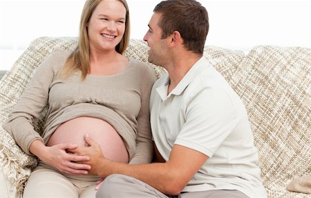 simsearch:400-07322828,k - Happy man touching the belly of his pregnant wife while looking at each other Fotografie stock - Microstock e Abbonamento, Codice: 400-04266836