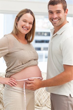 simsearch:400-04266840,k - Adorable future parents with a measuring tape in the living room Photographie de stock - Aubaine LD & Abonnement, Code: 400-04266860
