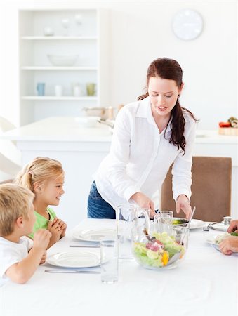 simsearch:400-04792006,k - adorable mother serving salad to her children for lunch standing in the kitchen Stock Photo - Budget Royalty-Free & Subscription, Code: 400-04267324