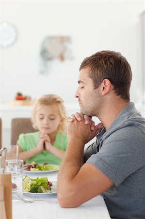 simsearch:400-04792006,k - Adorable father and daughter praying during the lunch in the kitchen Stock Photo - Budget Royalty-Free & Subscription, Code: 400-04267328
