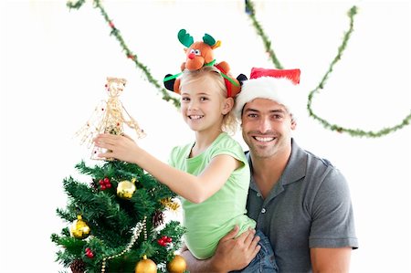 decorating small xmas tree - Happy father and daughter decorating together the christmas tree at home Stock Photo - Budget Royalty-Free & Subscription, Code: 400-04267323