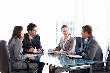 Businessmen and businesswomen talking during a meeting sitting at a table Stock Photo - Budget Royalty-Free & Subscription, Code: 400-04267339