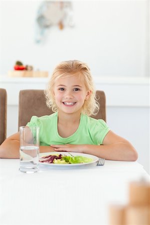 Smart girl sitting at a table to eat her healthy salad in the kitchen Stock Photo - Budget Royalty-Free & Subscription, Code: 400-04267333