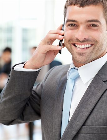 simsearch:400-04113098,k - Cheerful businessman on the phone during a meeting with his team in the office Stock Photo - Budget Royalty-Free & Subscription, Code: 400-04267347